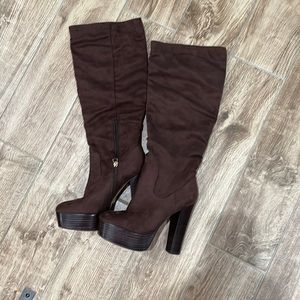 Jlo tall brown boots with platform heel.